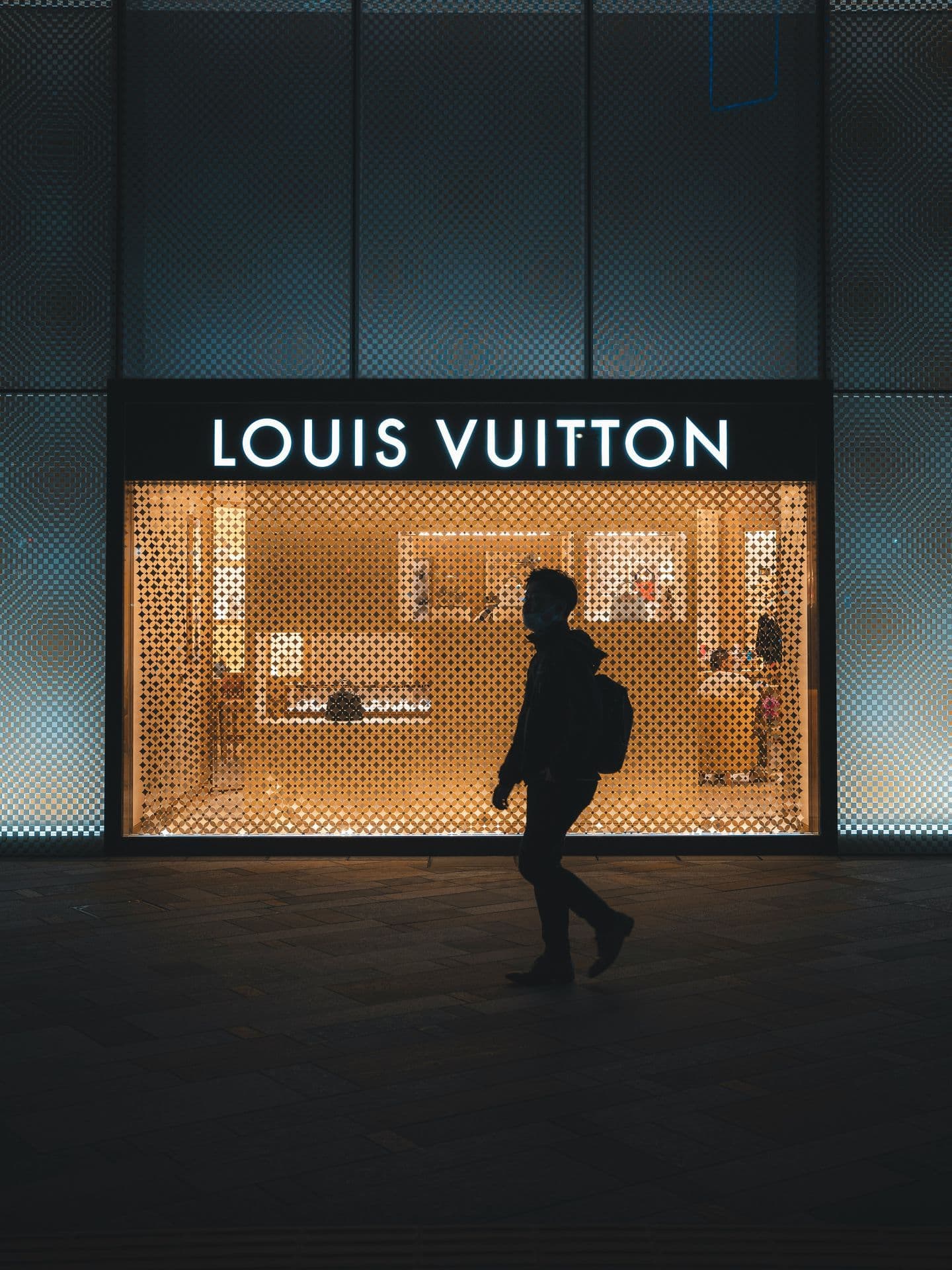 Silhouette passing luxury storefront